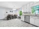 Bright eat-in kitchen with white cabinets, granite countertops, and stainless steel appliances at 9955 Rivertown Rd, Fairburn, GA 30213