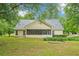 Large backyard with established lawn and mature trees surrounding the property at 10 Hollow Ct, Covington, GA 30016