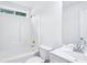 All-white bathroom with tub shower combination, commode, vanity, and large mirror at 10 Hollow Ct, Covington, GA 30016