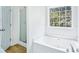 Bathroom featuring a soaking tub, a window with natural light, and a separate shower at 10 Hollow Ct, Covington, GA 30016