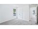 Light and airy bedroom with neutral carpet, closet, white walls, double hung window, and doorway to hallway at 10 Hollow Ct, Covington, GA 30016