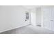 Neutral bedroom with fresh grey carpet, white walls, double door closet, and a double-hung window at 10 Hollow Ct, Covington, GA 30016
