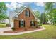 Brick home with a two-car garage, well maintained lawn, and mature trees at 10 Hollow Ct, Covington, GA 30016