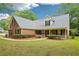 Attractive two-story brick home features a well-kept lawn and a welcoming front porch with white picket railing at 10 Hollow Ct, Covington, GA 30016