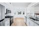 Modern kitchen features granite countertops, stainless steel appliances, and an adjacent sunlit breakfast nook at 10 Hollow Ct, Covington, GA 30016