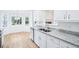 Bright kitchen with granite countertops, stainless steel appliances and a breakfast nook with large windows at 10 Hollow Ct, Covington, GA 30016