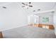 Spacious living room featuring plush carpeting, vaulted ceiling, and natural light flowing through the adjacent dining area at 10 Hollow Ct, Covington, GA 30016
