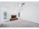 Cozy living room featuring plush carpeting, a fireplace with white mantel, and a glass door leading to an outdoor space at 10 Hollow Ct, Covington, GA 30016