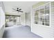 Access the kitchen from the screened porch featuring a ceiling fan and pleasant views at 10 Hollow Ct, Covington, GA 30016