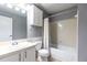 Full bathroom with shower-tub combo, single sink vanity, and neutral tile at 1818 Huntingdon Chase, Atlanta, GA 30350