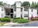 Apartment complex featuring lush landscaping, private balconies, and garden areas at 1818 Huntingdon Chase, Atlanta, GA 30350