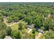 Areal view of a charming home surrounded by lush greenery and neighborhood homes at 302 Davis Rd, Stockbridge, GA 30281