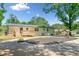 Backyard with a wooden deck, exterior door, and a well-manicured lawn at 302 Davis Rd, Stockbridge, GA 30281