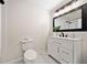 Bathroom with white vanity, marble floors, and a large mirror with modern lighting at 302 Davis Rd, Stockbridge, GA 30281