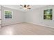 This bedroom features light walls and floors and two windows for plenty of natural light at 302 Davis Rd, Stockbridge, GA 30281