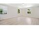 Bedroom featuring hardwood floors and natural light from the three windows at 302 Davis Rd, Stockbridge, GA 30281
