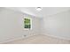 This bright bedroom features a window with views of the yard and light wood-look flooring at 302 Davis Rd, Stockbridge, GA 30281