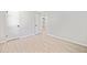 A sunny bedroom featuring light wood-look floors, white trim, and white painted walls at 302 Davis Rd, Stockbridge, GA 30281