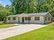 Traditional style home, well-manicured lawn, inviting entrance at 302 Davis Rd, Stockbridge, GA 30281