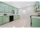 Newly renovated kitchen with stainless steel appliances, light green cabinets, and durable floors at 302 Davis Rd, Stockbridge, GA 30281
