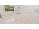 Spacious living room with large window, white trim, and light wood-look flooring at 302 Davis Rd, Stockbridge, GA 30281