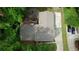 Aerial view shows a long driveway, mature trees and a patio with fire pit in backyard at 3311 Creek Hollow Dr, Marietta, GA 30062