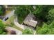 Aerial view showcases the house, with a long driveway and mature trees surrounding the property at 3311 Creek Hollow Dr, Marietta, GA 30062