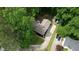 Aerial view showing the home with backyard fire pit, exterior storage, and driveway at 3311 Creek Hollow Dr, Marietta, GA 30062