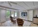 Well-lit basement features a seating area, TV, and natural light from large windows at 3311 Creek Hollow Dr, Marietta, GA 30062