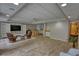 Spacious basement features wood-look floors, kitchenette, and comfortable seating area at 3311 Creek Hollow Dr, Marietta, GA 30062