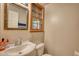 Bright bathroom with a sink, toilet, mirror, and window at 3311 Creek Hollow Dr, Marietta, GA 30062