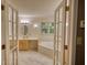 En-suite bathroom with double doors, featuring a soaking tub, vanity, and natural light at 3311 Creek Hollow Dr, Marietta, GA 30062