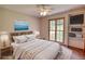 Comfortable bedroom features a ceiling fan, window, and shelving with a TV for relaxing or entertaining at 3311 Creek Hollow Dr, Marietta, GA 30062