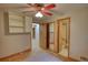 Cozy bedroom with closet, ceiling fan, and doorway to a full bathroom at 3311 Creek Hollow Dr, Marietta, GA 30062