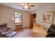 Bright bedroom featuring a ceiling fan, window, and a desk area for working at 3311 Creek Hollow Dr, Marietta, GA 30062