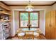 Eat-in kitchen area with a glass top table set, large windows, and wooden shelves at 3311 Creek Hollow Dr, Marietta, GA 30062