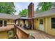 Wooden deck with a gazebo, seating area, brick chimney, and access to the home's interior at 3311 Creek Hollow Dr, Marietta, GA 30062