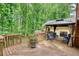 Outdoor deck featuring a gazebo with curtains and comfortable seating with stairs to backyard at 3311 Creek Hollow Dr, Marietta, GA 30062