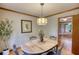 Dining room with a wooden oval table, modern light fixture, neutral wall color and hardwood floor at 3311 Creek Hollow Dr, Marietta, GA 30062