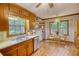 Eat-in kitchen area with stainless steel appliances, wooden cabinetry, large windows, and dining set at 3311 Creek Hollow Dr, Marietta, GA 30062
