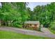 Charming home with shutters, a long driveway, and mature trees surrounding the property at 3311 Creek Hollow Dr, Marietta, GA 30062
