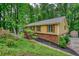Charming home with brick accents, shutters, and a wooden porch nestled in trees at 3311 Creek Hollow Dr, Marietta, GA 30062