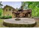 Two-story home with wooden deck, stone patio, and outdoor fire pit for entertaining guests at 3311 Creek Hollow Dr, Marietta, GA 30062