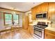 Kitchen with stainless steel appliances, wooden cabinets, breakfast table and a view of the deck at 3311 Creek Hollow Dr, Marietta, GA 30062