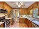 Well-lit kitchen featuring stainless steel appliances, wood cabinets, and view into the dining room at 3311 Creek Hollow Dr, Marietta, GA 30062