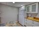 Bright kitchenette with white cabinetry, white refrigerator, and butcher block countertops at 3311 Creek Hollow Dr, Marietta, GA 30062
