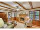 Cozy living room featuring a brick fireplace, exposed beam ceiling, and natural light at 3311 Creek Hollow Dr, Marietta, GA 30062