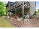 An angled view of a backyard and covered deck featuring dining, hot tub, and grilling spaces at 436 Barnett St, Woodstock, GA 30188