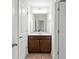 This bathroom features a brown vanity and neutral walls at 436 Barnett St, Woodstock, GA 30188