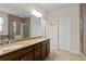 Bathroom boasts double sink vanity, tile flooring, glass enclosed shower and a soaking tub at 436 Barnett St, Woodstock, GA 30188